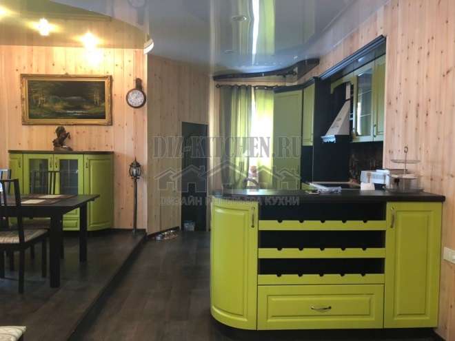 Green neoclassical kitchen made of MDF in a niche