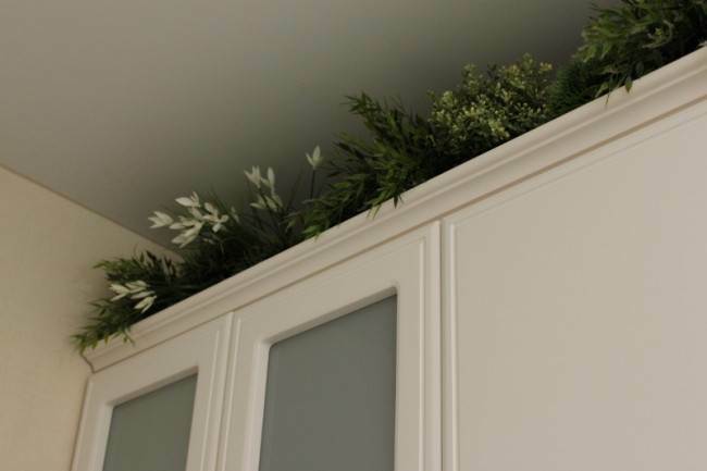 Artificial flowers above the cabinets 