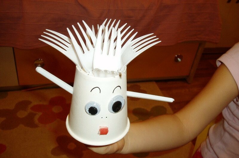 A doll made of disposable forks and a plastic cup