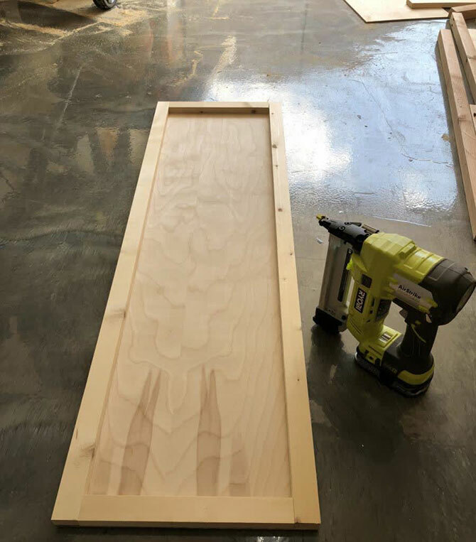 A backdrop for a mirror sheet is made from a sheet of plywood