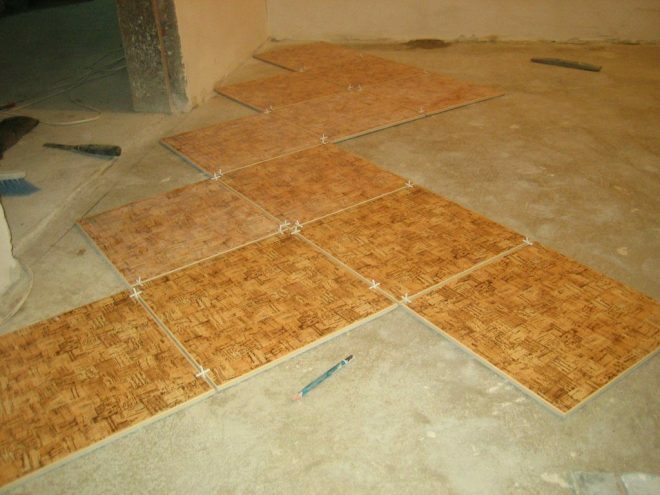 Laying tiles on the floor in the kitchen