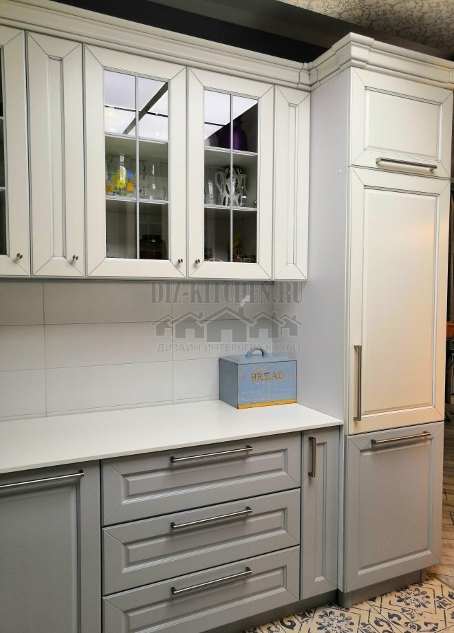White and gray U-shaped classic kitchen with a window in the center
