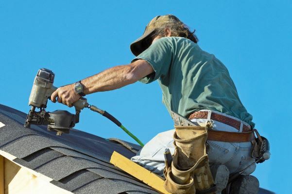 Installateur op het dak van het huis