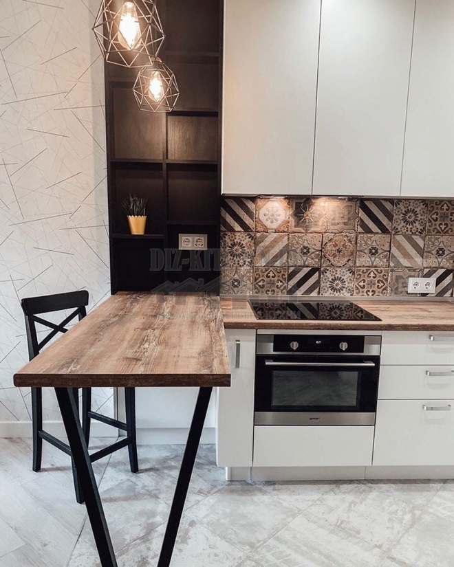 Kitchen in a studio apartment with a bright tiled backsplash